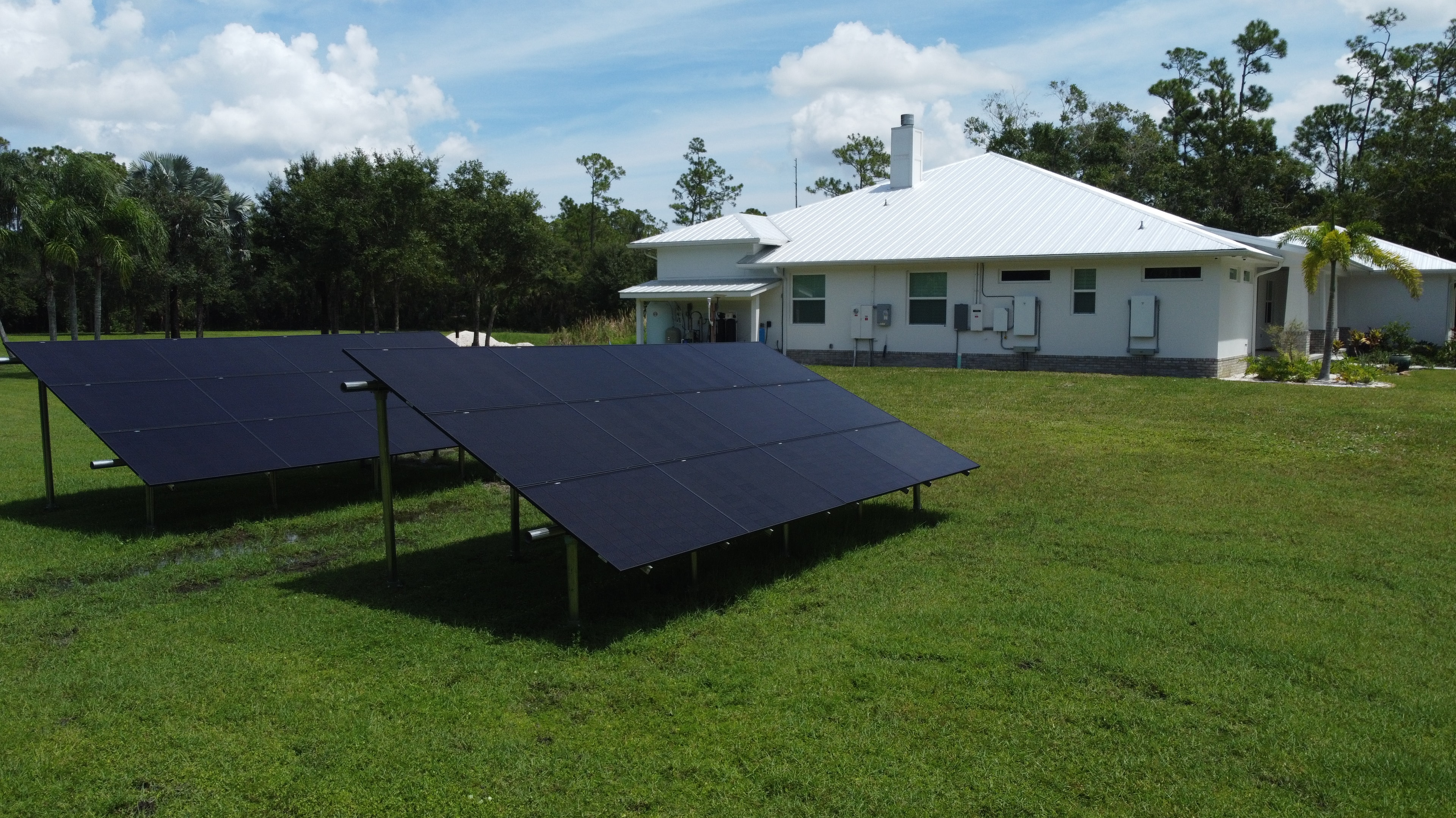 Solar panels powering a modern white home